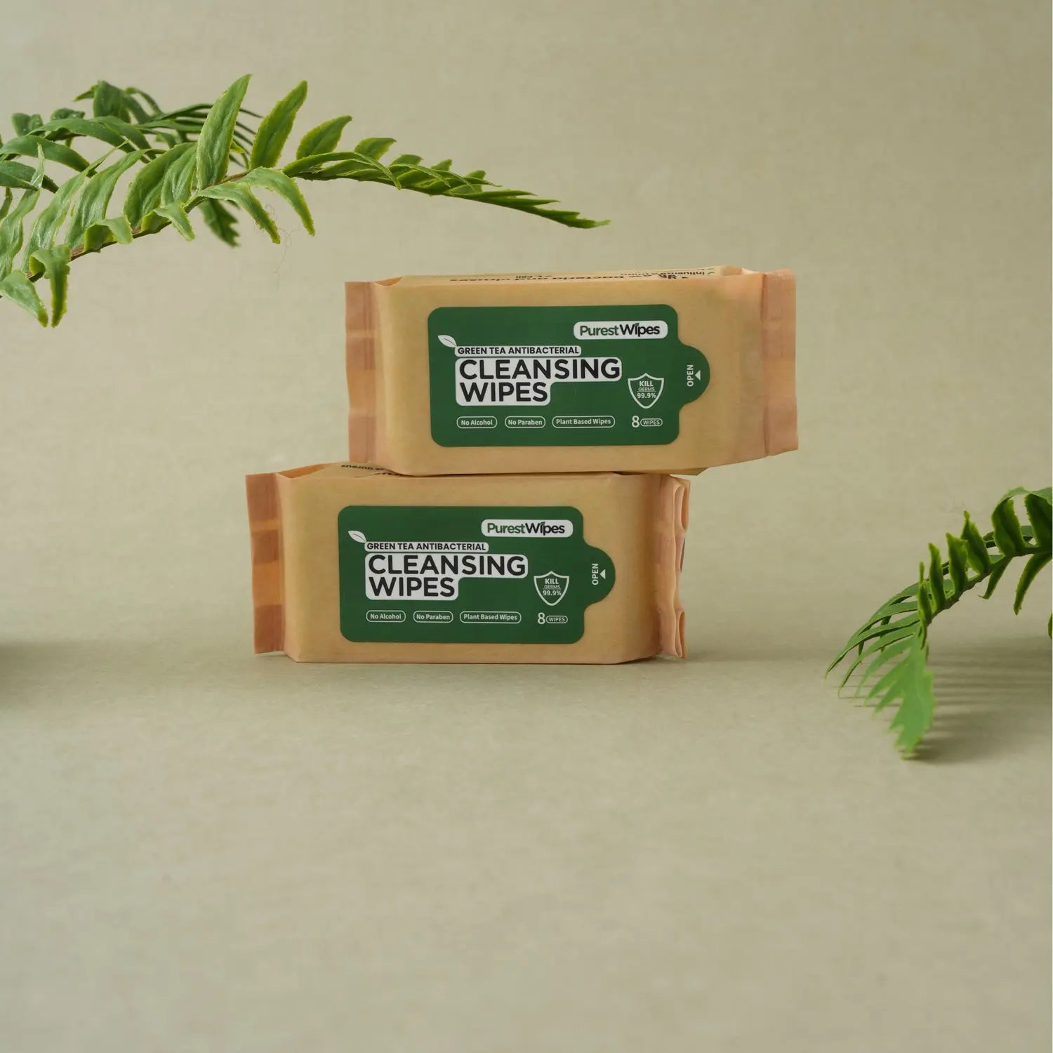 Two PurestWipes packets photographed with green foliage